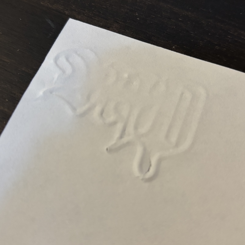 Embossed monogram on paper